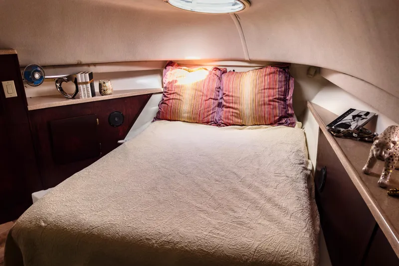 Slide: The Image of Cozy cabin bedroom in 2001 Sandpiper 50 yacht with decorative pillows and ambient lighting. - 11