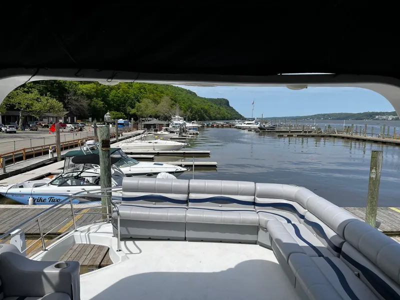 Slide: The Image of Luxurious 2001 Sandpiper 50 boat docked at a scenic marina with lush greenery. - 15