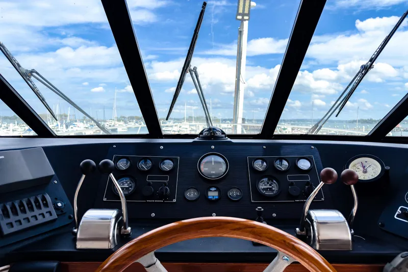 Slide: The Image of Cockpit view of a 2001 Sandpiper 50 boat with control panel and steering wheel. - 17