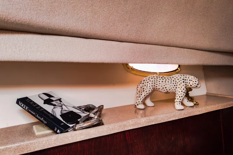Slide: The Image of Decorative shelf on Sandpiper 50 yacht with leopard figurine and Vogue book. - 19