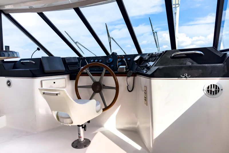Slide: The Image of Interior view of a 2001 Sandpiper 50 boat cockpit with steering wheel and controls. - 2