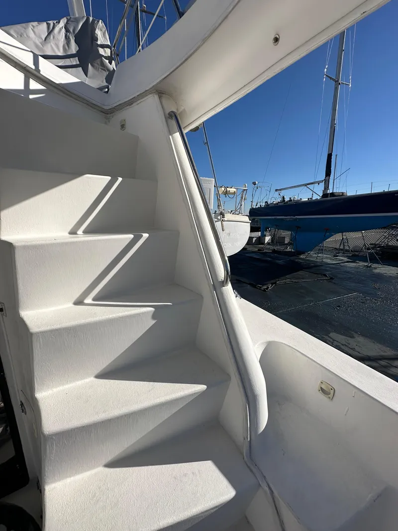 Slide: The Image of Staircase on a 2001 Sandpiper 50 yacht, docked with clear blue sky. - 28