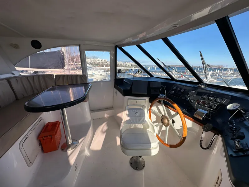 Slide: The Image of Interior of a 2001 Sandpiper 50 boat with steering wheel and seating area. - 29