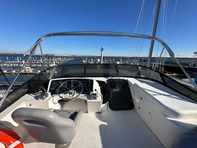 Slide: The Image of Helm of 2001 Sandpiper 50 boat with marina view under clear blue sky. - 31