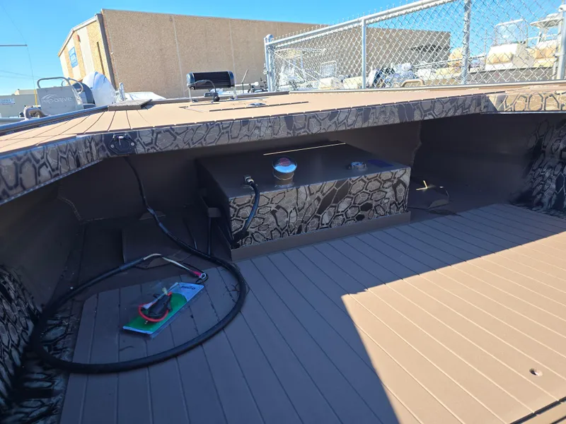 Slide: The Image of 2024 Pro-Drive X Series 1860 CC boat interior with storage compartment and wiring. - 11