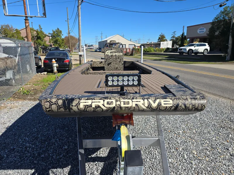 Slide: The Image of 2024 Pro-Drive X Series 1860 CC boat on trailer, outdoor setting. - 4