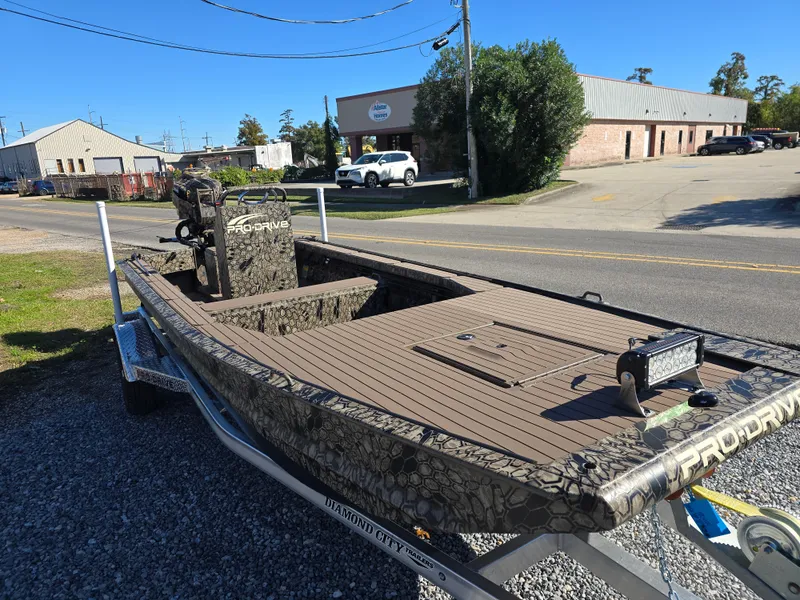 Slide: The Image of 2024 Pro-Drive X Series 1860 CC boat on trailer, parked outdoors. - 5