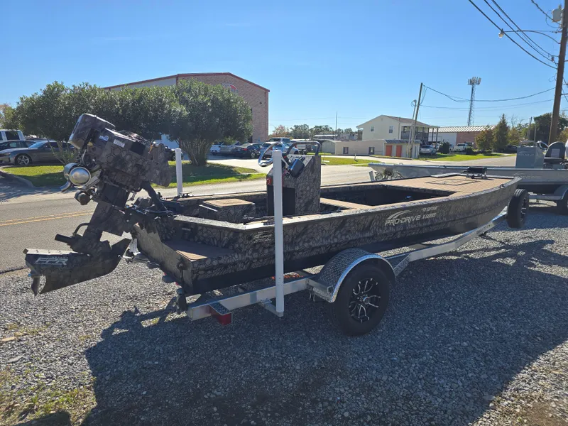Slide: The Image of 2024 Pro-Drive X Series 1860 CC boat on trailer, parked outdoors. - 6