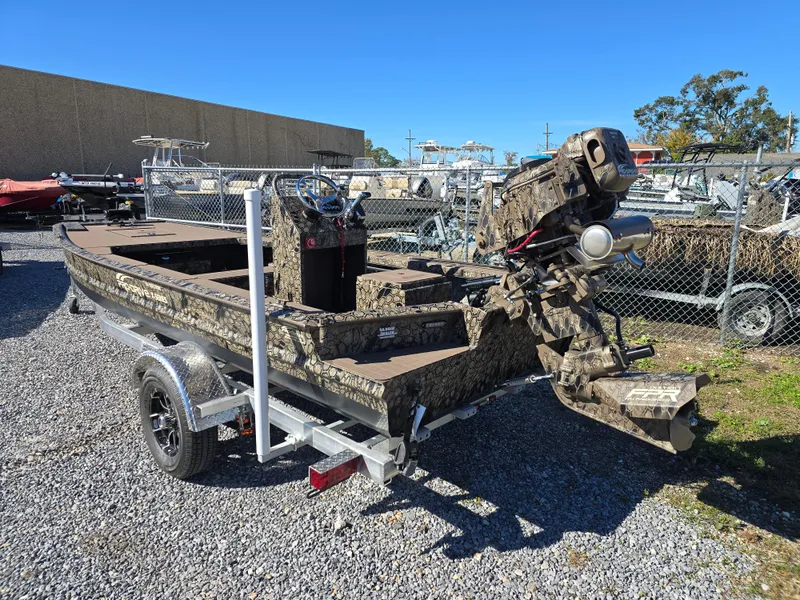 Slide: The Image of 2024 Pro-Drive X Series 1860 CC boat on trailer, camouflage design, outdoor display. - 9