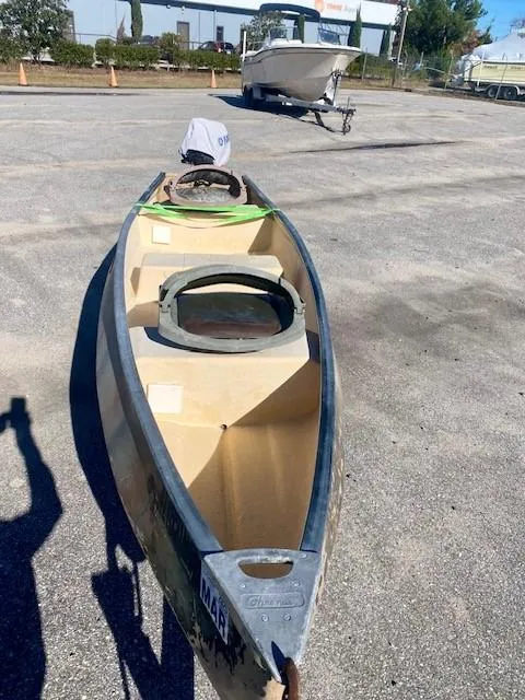 Slide: The Image of 1999 Gheenoe 13' boat on pavement, with another boat in the background. - 10