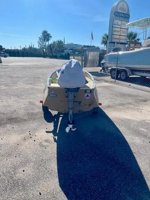 Slide: The Image of 1999 Gheenoe 13' boat parked outdoors on sunny day. - 5