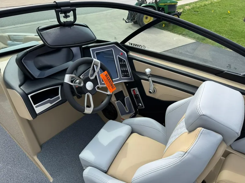 Slide: The Image of 2024 MasterCraft XT24 boat interior with modern dashboard and steering wheel. - 10