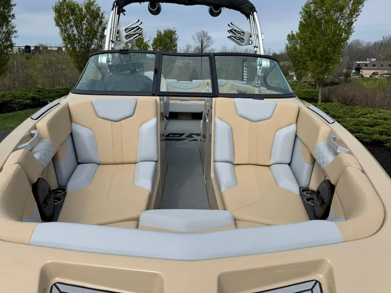 Slide: The Image of 2024 MasterCraft XT24 boat interior with beige and gray seating, open bow design. - 8