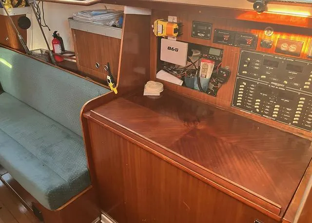 Slide: The Image of Interior of 1990 Beneteau Sloop with navigation equipment and wooden cabinetry. - 11