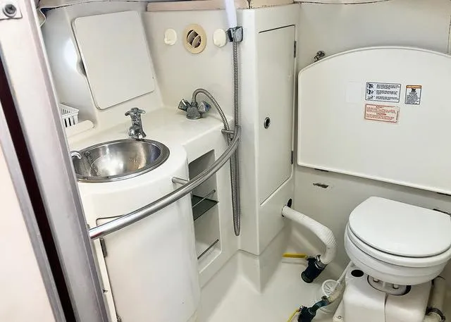 Slide: The Image of Compact bathroom in a 1990 Beneteau Sloop yacht with sink and toilet. - 15