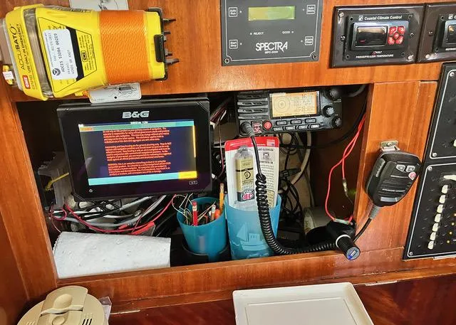 Slide: The Image of Navigation equipment and controls inside a 1990 Beneteau Sloop sailboat. - 19