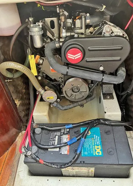 Slide: The Image of 1990 Beneteau Sloop engine compartment with battery and mechanical components. - 20