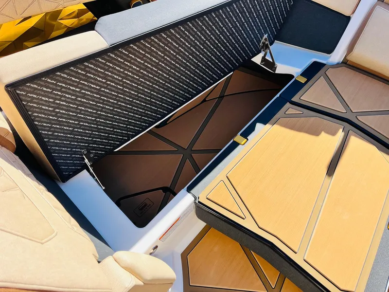 Slide: The Image of 2025 Nautique Super Air Nautique G25 Paragon interior storage compartment with stylish seating. - 16