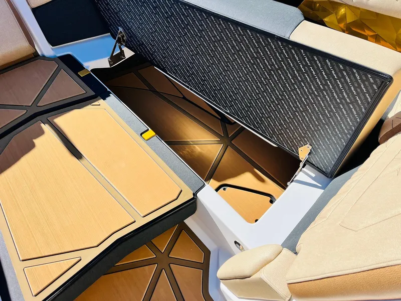 Slide: The Image of 2025 Nautique Super Air Nautique G25 Paragon interior storage compartment with tan upholstery. - 17