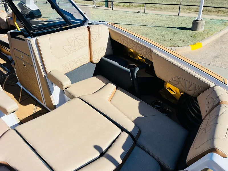 Slide: The Image of 2025 Nautique Super Air Nautique G25 Paragon interior with luxurious beige seating. - 24
