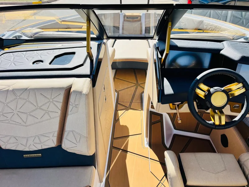 Slide: The Image of 2025 Nautique Super Air Nautique G25 Paragon interior with luxurious seating and modern steering wheel. - 28