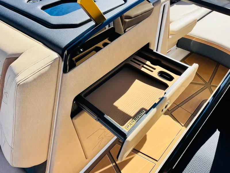 Slide: The Image of 2025 Nautique Super Air Nautique G25 Paragon interior with open storage drawer. - 31