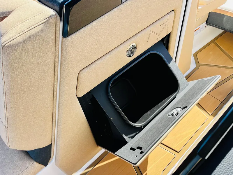 Slide: The Image of 2025 Nautique Super Air Nautique G25 Paragon storage compartment with beige interior. - 32