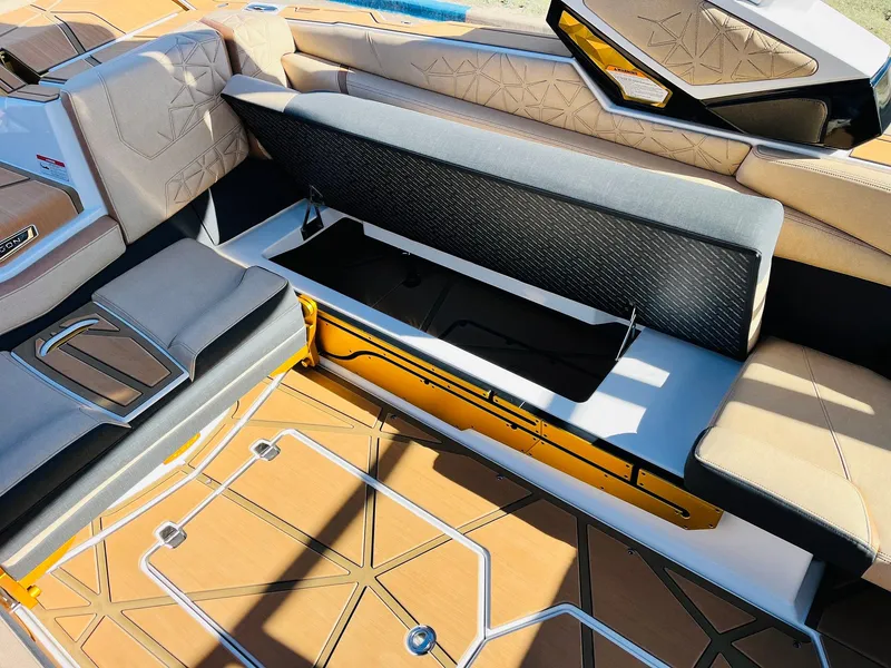 Slide: The Image of 2025 Nautique Super Air Nautique G25 Paragon interior seating with storage compartment. - 44