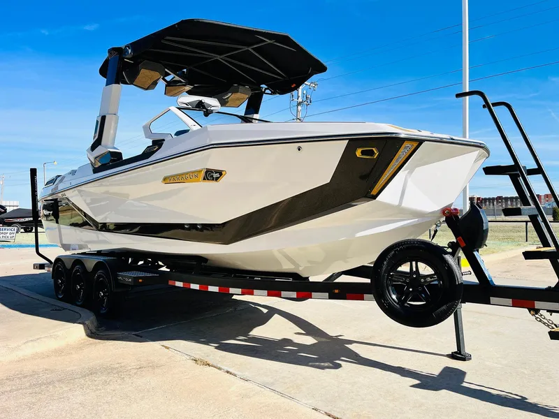 Slide: The Image of 2025 Nautique Super Air Nautique G25 Paragon boat on trailer, sunny day. - 5