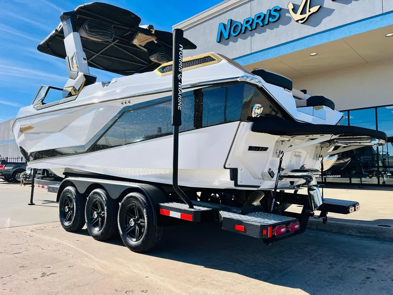 Slide: The Image of 2025 Nautique Super Air Nautique G25 Paragon boat on trailer outside dealership. - 9