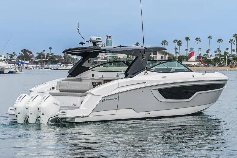 Slide: The Image of 2024 Cruisers Yachts 38 GLS OB on water, featuring sleek design and triple outboard engines. - 2