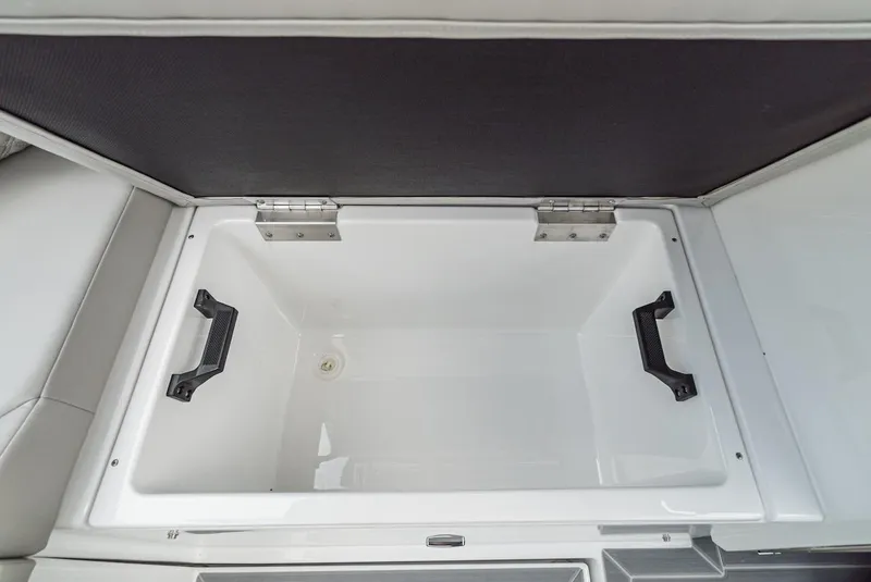 Slide: The Image of 2024 Cruisers Yachts 38 GLS OB storage compartment with open lid and handles. - 33