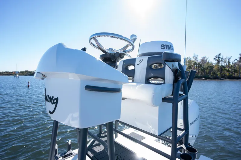 Slide: The Image of Young Boats 24, 2022 model, on water with clear sky and trees in background. - 11