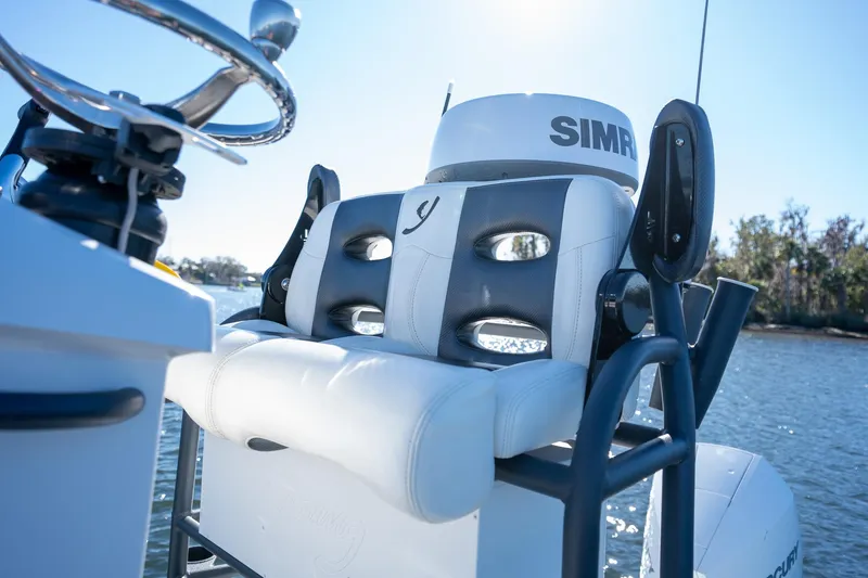 Slide: The Image of 2022 Young Boats 24 helm seat with Simrad electronics on a sunny day. - 12