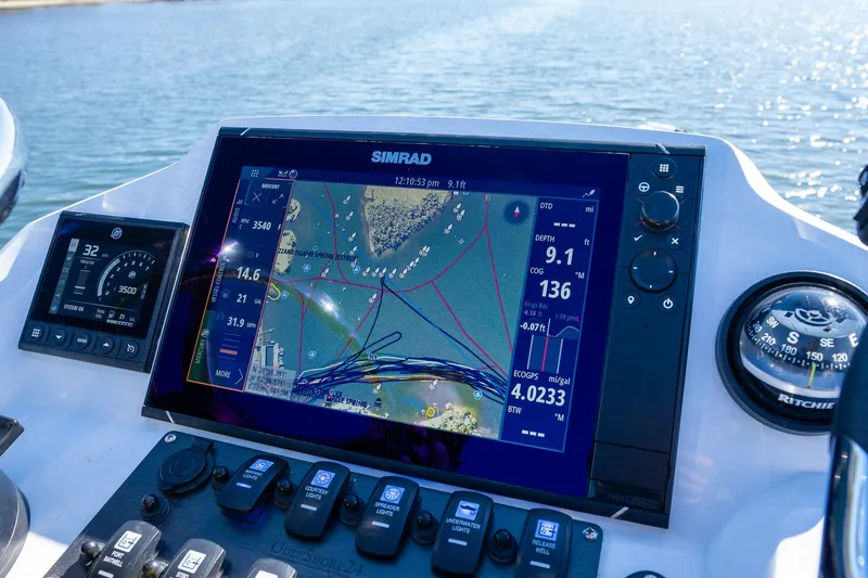 Slide: The Image of Young Boats 24 dashboard with Simrad navigation system, 2022 model, on a sunny day at sea. - 14