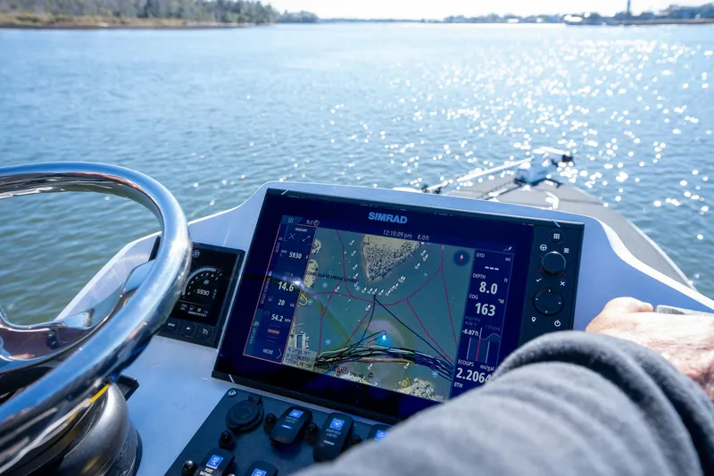 Slide: The Image of Young Boats 24, 2022 model, with navigation system on a sunny waterway. - 15