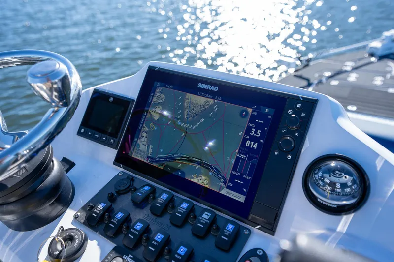 Slide: The Image of Young Boats 24 dashboard with Simrad navigation system, 2022 model, on water. - 17