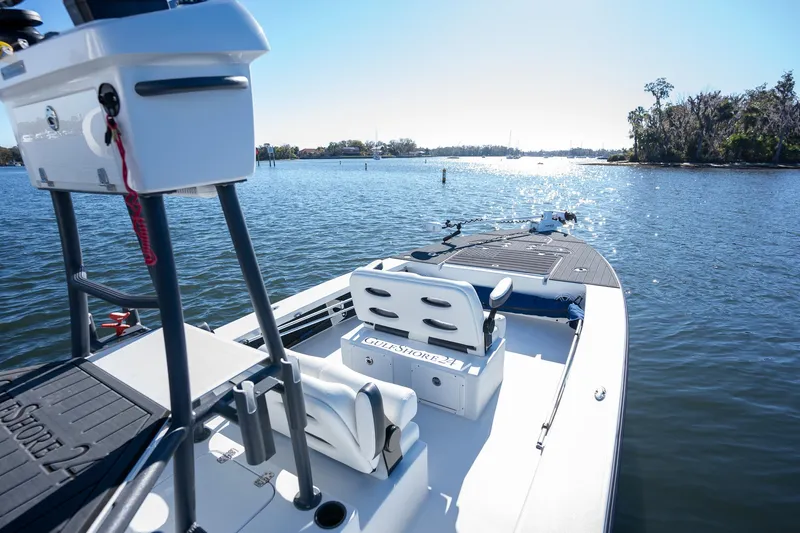 Slide: The Image of 2022 Young Boats 24 on serene lake with clear blue sky. - 18