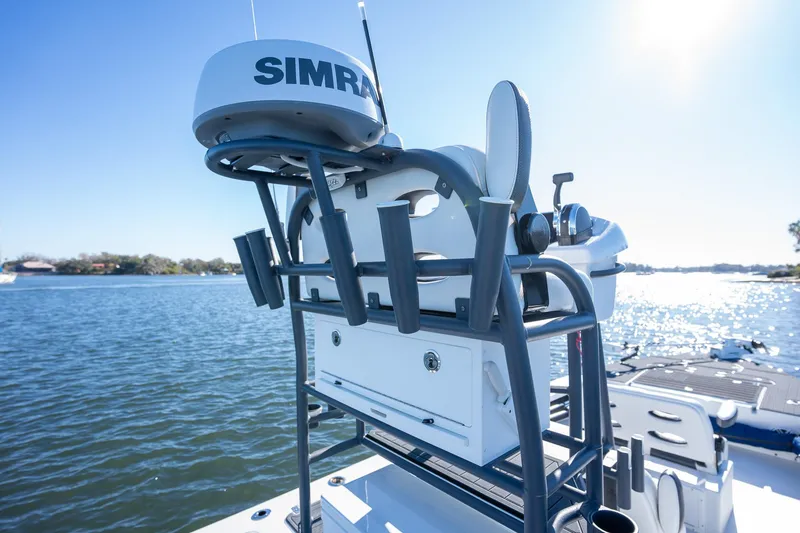 Slide: The Image of Young Boats 24, 2022 model, featuring Simrad equipment on a sunny day by the water. - 20