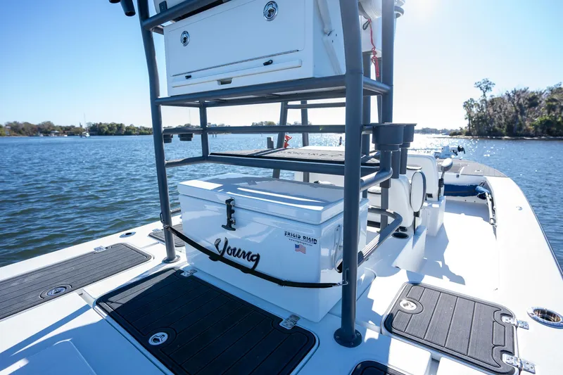 Slide: The Image of 2022 Young Boats 24 on water, featuring deck storage and seating. - 21