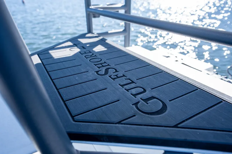 Slide: The Image of Young Boats 24 Gulfshore deck, 2022 model, overlooking sparkling water. - 27