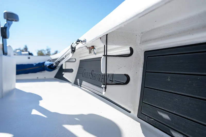 Slide: The Image of 2022 Young Boats 24 interior detail with rod holder and storage compartment. - 29