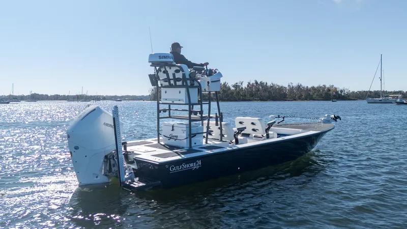 Slide: The Image of 2022 Young Boats 24 on water, featuring elevated helm and powerful outboard motor. - 34