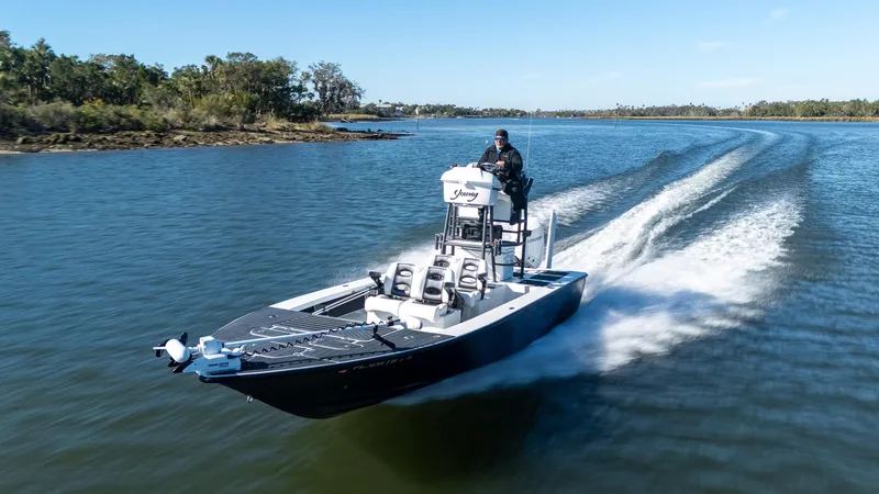 Slide: The Image of 2022 Young Boats 24 cruising on a scenic waterway. - 37