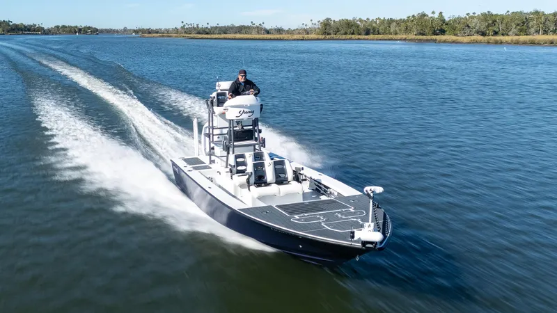 Slide: The Image of 2022 Young Boats 24 cruising on a serene lake. - 38