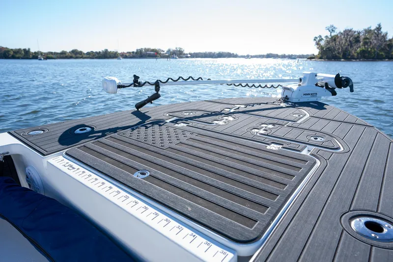 Slide: The Image of 2022 Young Boats 24 on water, featuring deck and fishing equipment. - 4