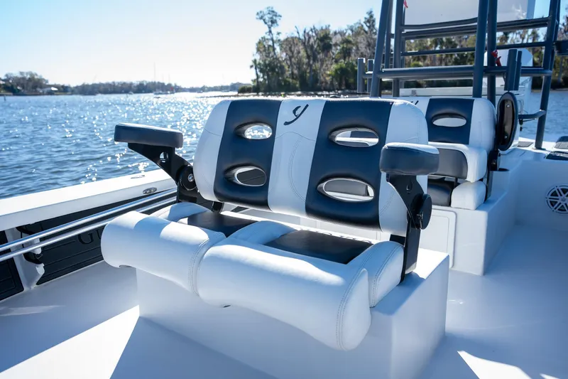 Slide: The Image of 2022 Young Boats 24 with comfortable seating on a sunny day by the water. - 7