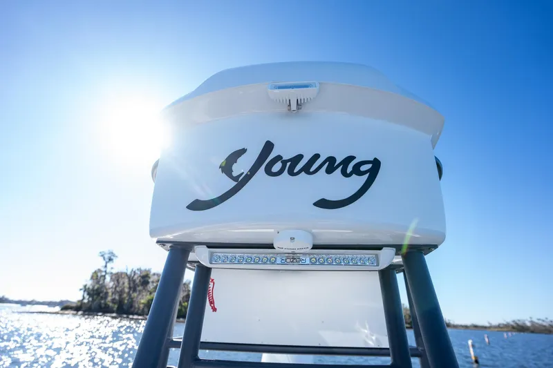Slide: The Image of Young Boats 24, 2022 model, on water with clear blue sky background. - 9