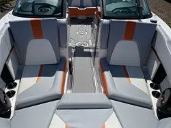Slide: The Image of 2024 MasterCraft X22 boat interior with orange and gray seating. - 13