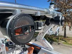 Slide: The Image of 2024 MasterCraft X22 boat interior with gray and orange seating, cup holders, and sleek design. - 14